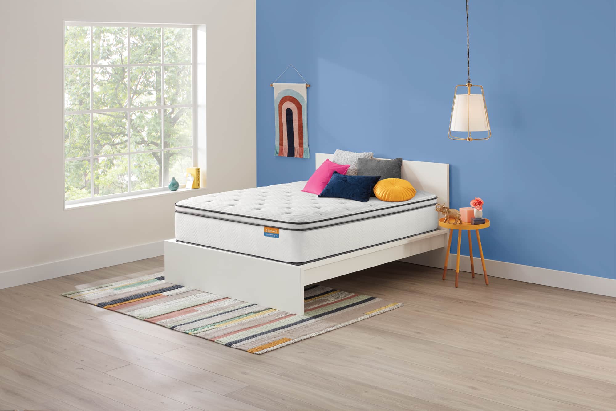 Simmons Dreamwell mattress in blue room with rug